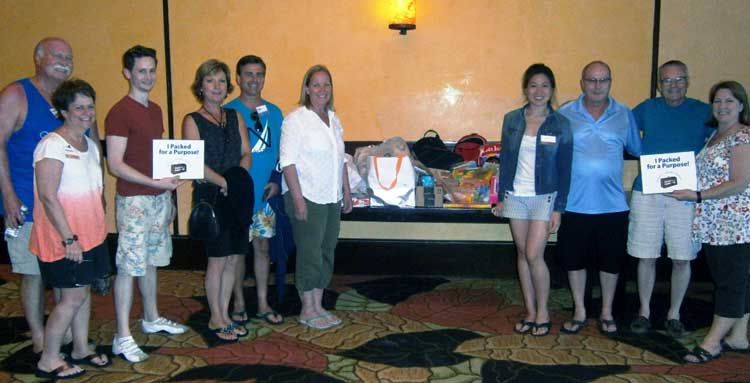 Senn Delaney employees with Pack for a Purpose supplies at Fairmont Mayakoba