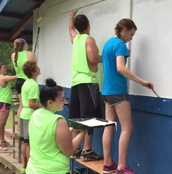 Volunteer Students Painting School