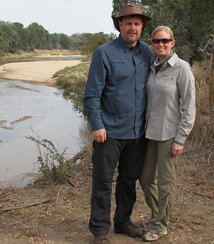 Stacy and her husband by a river in South Africa