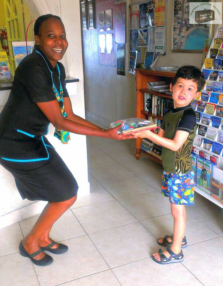 Child handing off supplies at the front desk