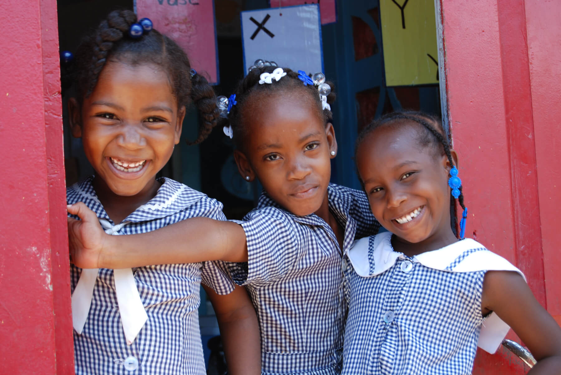 Young girls standing in doorway for school - Pack for a purpose