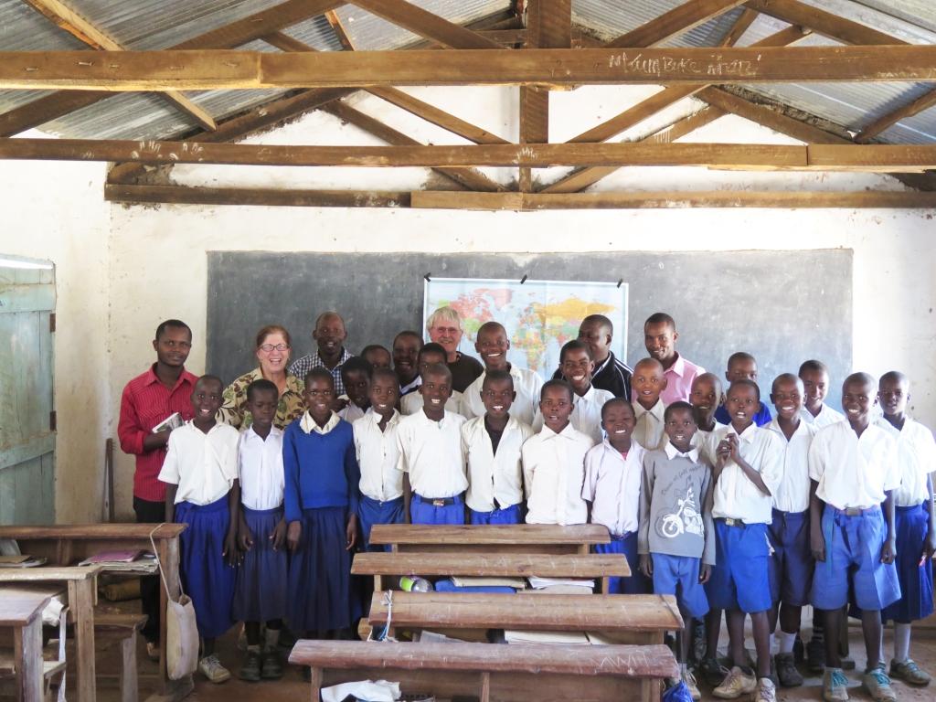 The class and teachers in front of the world map