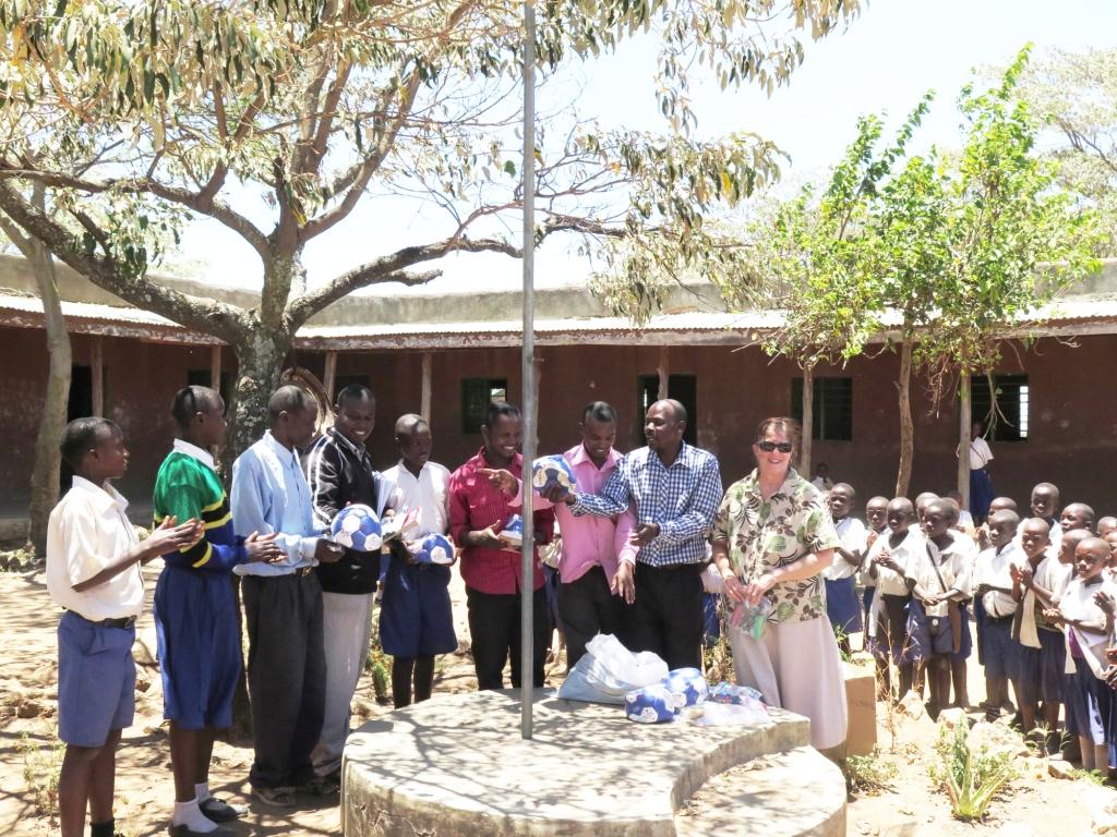 Supplies being handed out to students and teachers in the courtyard