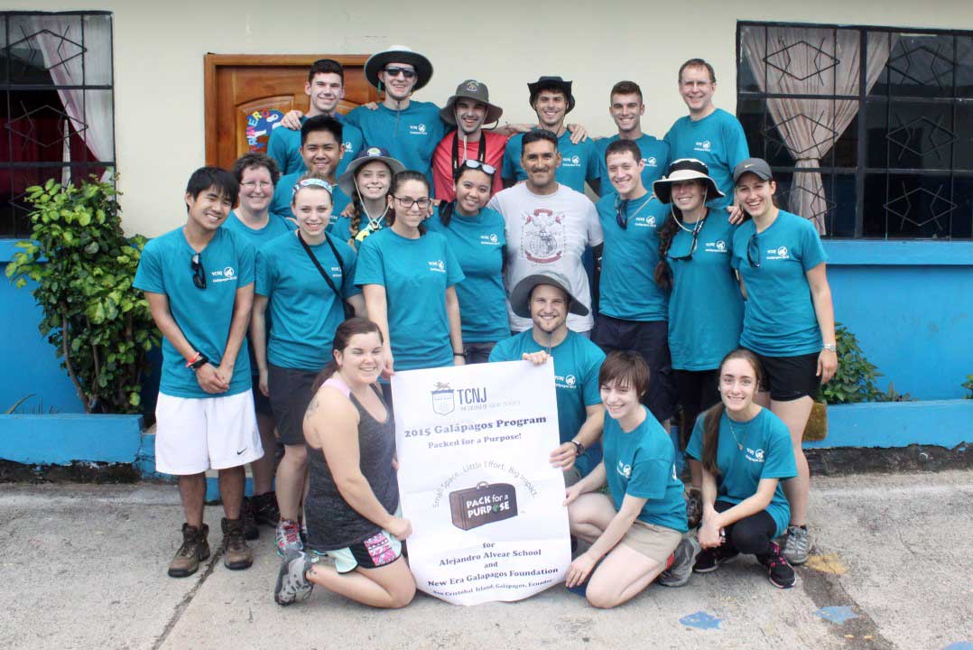 Students pose in front of the Alejandro Alvear School